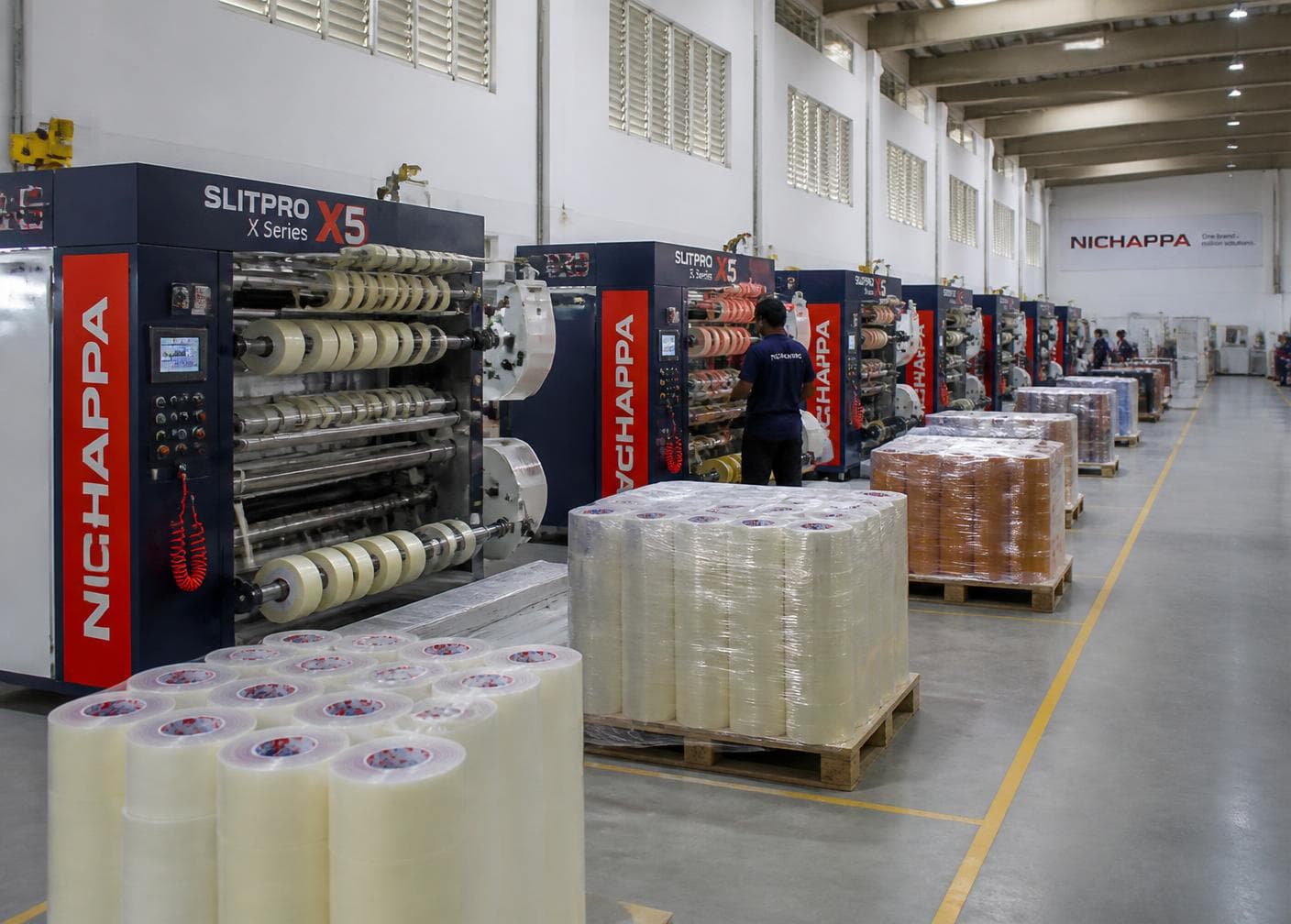 Slitting machines and pallets of finished tape inside the Sonison Packaging plant